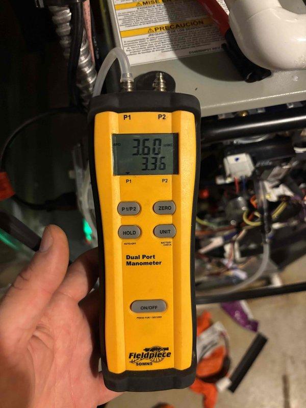 Completed heating maintenance member visit and performed comprehensive system diagnostics. Used digital multimeter to verify electrical readings and dual port manometer to measure static pressures, confirming system operating within manufacturer specifications at 36.8 and 33.6 readings across the air handler unit.