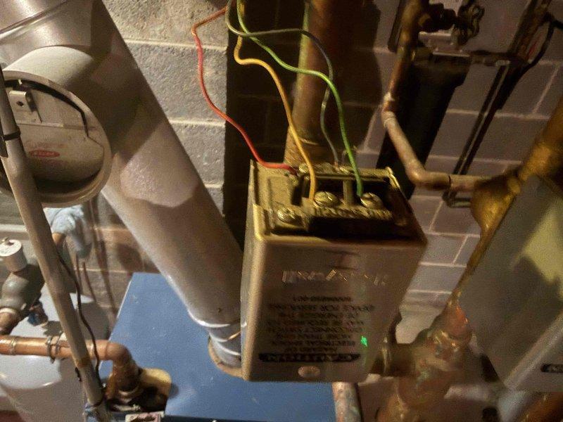 Conducted HVAC maintenance club visit and reviewed available maintenance plan options with homeowner for oil boiler heating system. Performed visual inspection of mechanical room equipment including boiler controls, zone valves, copper piping, and associated components. Documented system configuration with photos showing control relays, flow control devices, and water heater connections for service records.
