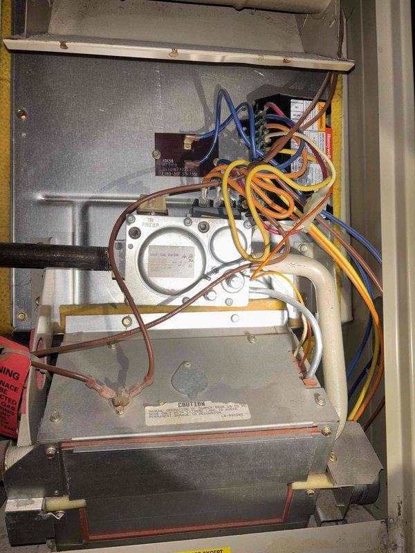 Completed annual heating maintenance and tune-up on 15-year-old furnace system. Performed comprehensive inspection of gas valve assembly, electrical connections, and control components. All colored wiring connections to gas valve terminals were inspected and found secure. Verified proper operation of Honeywell gas valve, pressure regulator, and control module. Checked circuit board functionality and transformer operation. Inspected condensate drainage system including PVC piping. All safety labels and warning tags confirmed present and legible. Unit interior showed minimal dust accumulation with no corrosion on components. System tested and confirmed operating within normal parameters for continued safe heating operation.