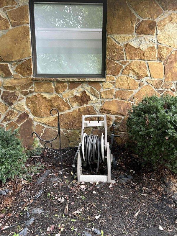 Completed heating system tune-up and installed new programmable thermostat per customer request. Serviced exterior hose bib at front of residence, inspecting outdoor HVAC equipment panel which showed weathering and oxidation consistent with age but remained structurally sound.