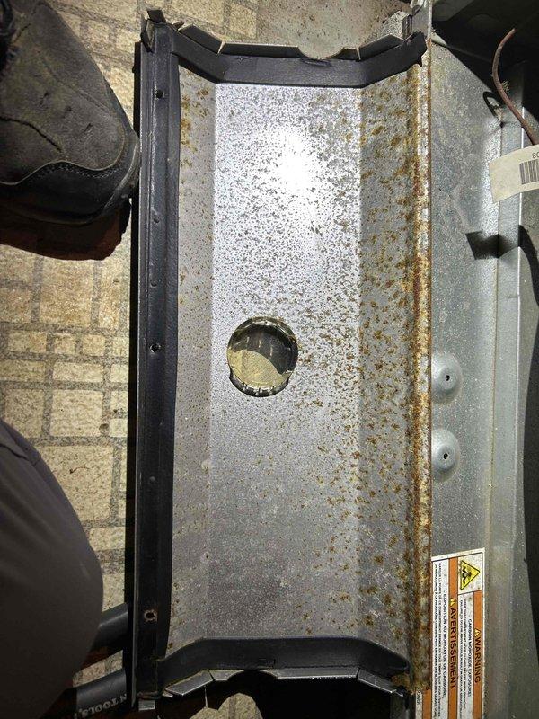 Completed heating system tune-up and installed new programmable thermostat per customer request. Serviced exterior hose bib at front of residence, inspecting outdoor HVAC equipment panel which showed weathering and oxidation consistent with age but remained structurally sound.