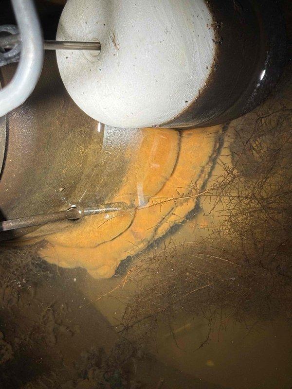 Responded to service call for dripping shower/tub faucet with difficult shut-off operation. Upon arrival, inspected the bathroom plumbing fixtures as reported. During the property assessment, discovered a water heater with significant rust staining on the floor beneath the unit, indicating active leakage from the tank base. The water heater, a US/Craftmaster 40-gallon natural gas unit manufactured in 2016, showed clear signs of tank failure with extensive corrosion and water damage to the surrounding floor area. Advised customer of the critical water heater condition requiring immediate attention to prevent further water damage and potential flooding. Recommended water heater replacement as the primary concern due to the active leak and age of the unit. The original faucet repair was deferred to address the more urgent water heater failure.