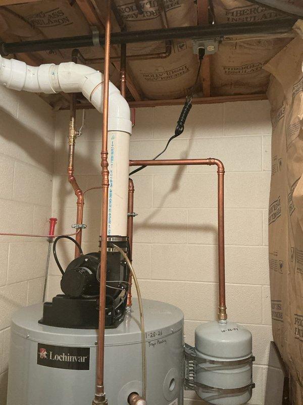 Installed new Lochinvar tanked water heater system to replace existing recirculation water heater that was causing extended wait times of up to 20 minutes for hot water delivery to remote areas of the residence. Installation included mounting of expansion tank with metal strapping, connection of copper supply and return piping with brass fittings, installation of circulator pump assembly on top of unit, and routing of PVC venting system through ceiling joists. System was pressure tested, all connections verified for proper operation, and unit commissioned to ensure adequate hot water delivery throughout the home.