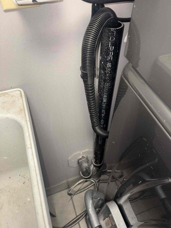 Completed rough-in measurements and site assessment for toilet installation requiring concrete demolition. Measured spacing between existing copper supply lines protruding from floor to ensure proper fixture placement and compliance with plumbing code requirements for new toilet rough-in.
