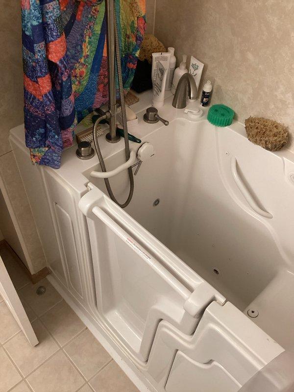 Completed comprehensive plumbing maintenance inspection as part of club membership visit. Evaluated residential plumbing systems including walk-in bathtub with side-entry door, handheld shower assembly, and basement utility area with washing machine connections and utility sink. Documented existing plumbing conditions with photographic records, noting copper supply lines and drainage systems throughout the property were functioning properly at time of inspection.