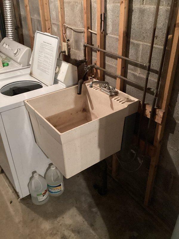 Completed comprehensive plumbing maintenance inspection as part of club membership visit. Evaluated residential plumbing systems including walk-in bathtub with side-entry door, handheld shower assembly, and basement utility area with washing machine connections and utility sink. Documented existing plumbing conditions with photographic records, noting copper supply lines and drainage systems throughout the property were functioning properly at time of inspection.