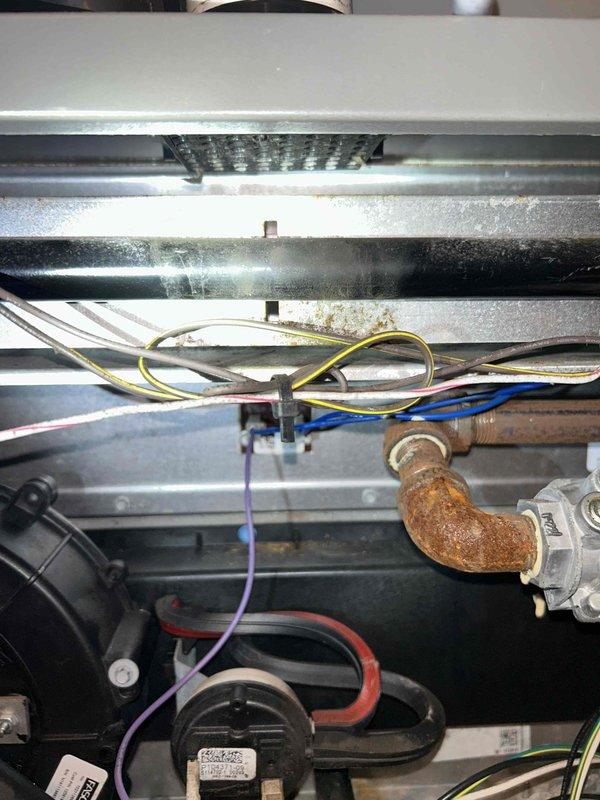 Completed final prepaid heating maintenance visit on air handler system. Performed comprehensive inspection of HVAC control panel, low-voltage wiring assembly, and internal mechanical components. Documented existing conditions including visible corrosion on base platform and copper piping connections, along with dust accumulation on heat exchanger panels and operational wear consistent with system age. All electrical connections, terminal blocks, relays, and control wiring verified as secure and functional during routine maintenance inspection.
