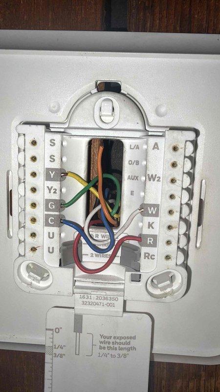 Returned to complete fan motor replacement on HVAC system, with materials ordered from supplier and expected delivery confirmed. Inspected thermostat wiring and control board connections to address customer inquiry regarding heat pump auxiliary heating operation for winter oil consumption reduction. Verified thermostat configuration and documented existing wiring at both the air handler control board and wall thermostat, preparing system for proper heat pump operation with auxiliary heat functionality once replacement motor is installed.