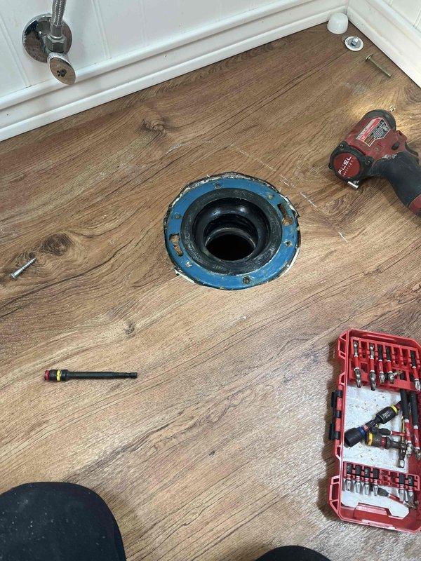 Responded to water leak originating from a 3" PVC wye fitting in the ceiling cavity. Customer had already removed drywall to expose the affected area. Upon arrival, inspected the gray PVC drainage pipe with visible leak at the wye connection point where a black rubber coupling or Fernco boot had failed. Replaced the defective flexible coupling with a proper fitting to restore watertight seal. Additionally addressed a toilet flange issue observed during the service call, completing necessary repairs to ensure proper function and prevent future leaks.