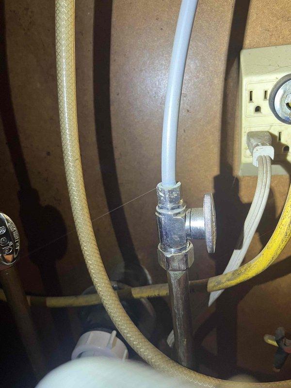 Responded to water leak under kitchen sink. Upon inspection, identified fine mist spray originating from plumbing connections at the shut-off valve assembly. Tightened braided supply line fittings and chrome-plated valve connections to eliminate leak. Verified all connections were secure and tested system under pressure to confirm repair was successful with no further water discharge detected.