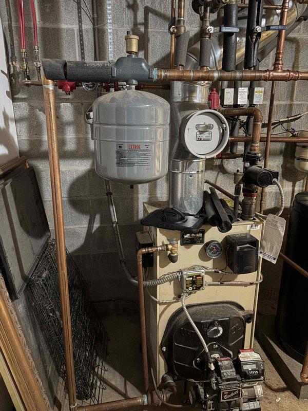 Completed boiler system upgrade including installation of new expansion tank, magnetic filtration system, and air vents. The expansion tank was properly mounted and integrated into the existing copper piping configuration to maintain correct system pressurization. A wiClean magnetic filter was installed in-line to remove ferrous debris and protect the boiler from sediment buildup, extending equipment life and maintaining efficiency. New automatic air vents were added at appropriate locations throughout the system to eliminate trapped air and ensure proper circulation. All connections were made with copper piping and brass fittings, pressure tested, and verified for proper operation.
