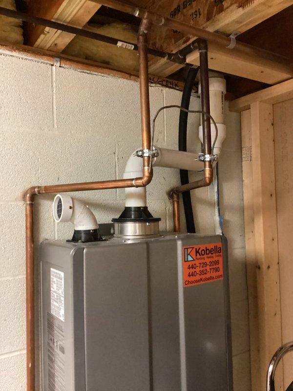 Performed comprehensive tankless water heater maintenance including inspection of copper supply lines, verification of proper mounting and connections, and system operational check. Unit was found to be functioning properly with all components in good working condition and plumbing fixtures operating as designed.