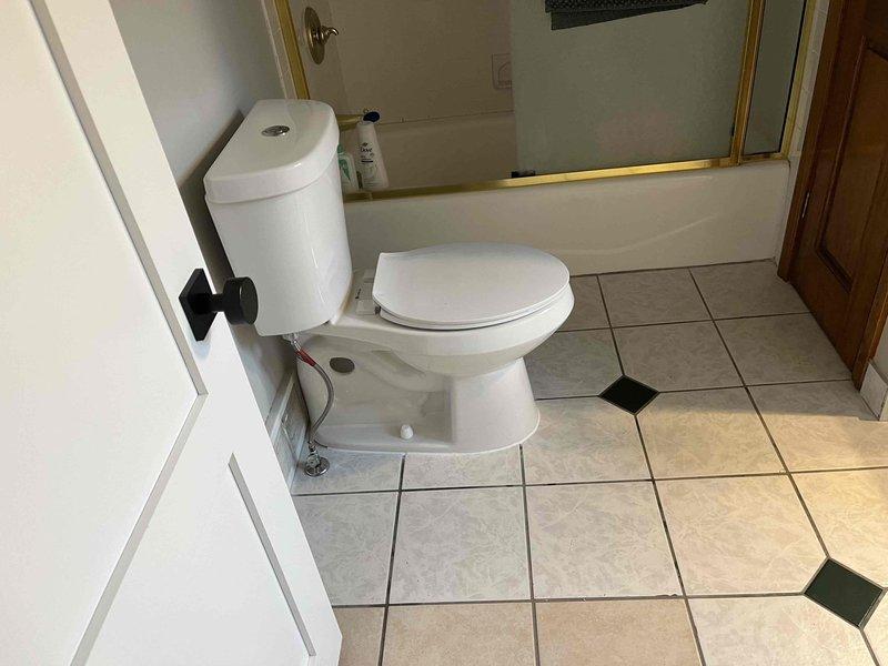 Responded to toilet leak at base of fixture. Previous wax ring replacement by homeowner did not resolve issue. Upon inspection, discovered severely corroded and deteriorated toilet flange with compromised mounting surface. Removed toilet, confirmed flange damage preventing proper seal. Installed new toilet flange repair kit and replacement wax ring with proper compression. Reset toilet, secured mounting bolts to manufacturer specifications, and tested for leaks. Verified proper seal and no water discharge at base.
