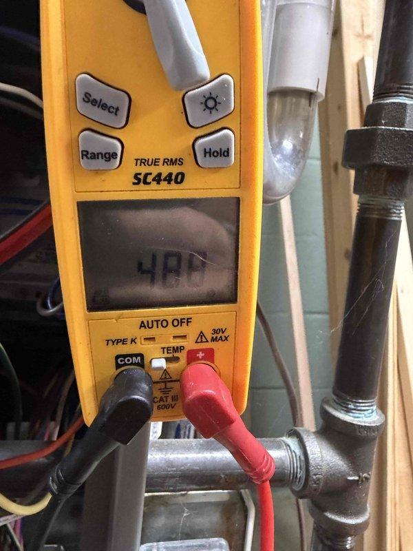 Completed final prepaid heating maintenance visit on air handler unit. Performed system diagnostics including electrical testing with multimeter, which confirmed proper voltage readings at 400V on system components. Inspected and removed damaged flame sensor rod showing significant corrosion and irregular bending, which was affecting system performance and requiring replacement.