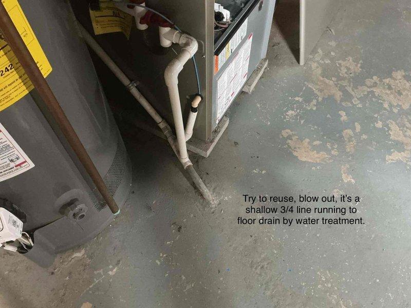 Conducted site visit to assess HVAC drainage system configuration. Evaluated existing 3/4" condensate line routing to floor drain near water treatment equipment and determined line could be reused by clearing blockage. Staged replacement ductwork components and metal pans on shelving for upcoming installation work.