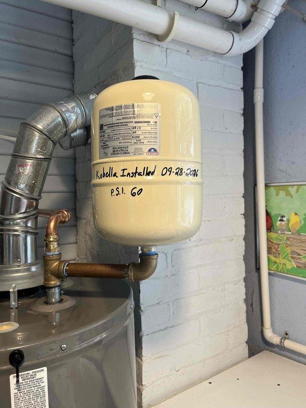 Responded to customer complaint of unusual filling noise occurring in bathroom regardless of which fixture was used. Inspected exterior pressure reducing valve (PRV) assembly and verified proper installation of all components including backflow preventer, water filter, and pressure gauge. Checked interior pressure tank system and confirmed recent installation with operating pressure set at 60 PSI. Tested system operation and verified all plumbing connections were secure with no visible leaks detected at PRV assembly or pressure tank connections.