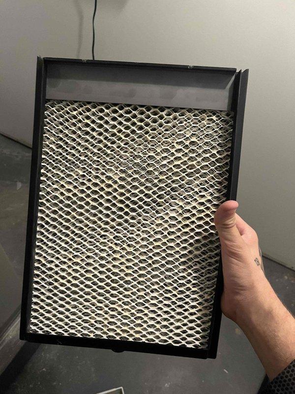 Responded to heating maintenance call regarding paint odor from recently installed furnace system. Performed comprehensive safety inspection of air handler and heating unit to address customer concerns about potential hazardous fumes. Inspected and documented condition of air filter, which showed significant dust and debris accumulation that could contribute to odor issues. Conducted carbon monoxide testing using calibrated digital meter, confirming safe levels at 0.06 reading with no dangerous gas present in system operation.