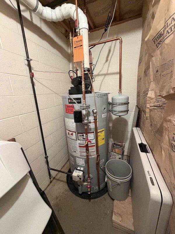 Completed follow-up visit for recirculation pump installation on existing Lochinvar water heater system. The recirculation pump was previously sold and received, then installed at the top of the water heater unit with proper copper piping connections and electrical wiring. Installation was coordinated around scheduling constraints and completed within the estimated two-hour timeframe. System includes expansion tank and all necessary safety components with proper labeling intact.