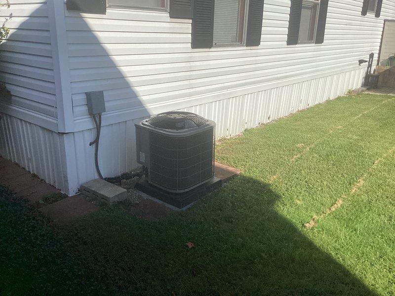 Conducted comprehensive HVAC system evaluation at single-story residential property with existing furnace and air conditioning system. Documented current equipment configuration including outdoor condensing unit mounted on concrete pad with proper electrical service and metal skirting foundation protection. Assessment completed to provide replacement estimate for aging heating and cooling equipment.