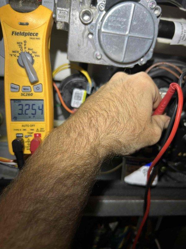 Completed heating maintenance club visit focusing on air balancing issues. Performed diagnostic testing on gas heating system using digital multimeter, recording operational readings at gas valve assembly to verify proper voltage and system performance. Inspected air handler filter assembly and documented condition showing moderate dust accumulation on pleated media, indicating normal service interval wear. Worked with technician to adjust airflow distribution throughout system to resolve balancing concerns. All heating components tested within normal operating parameters upon completion of three-hour service call.