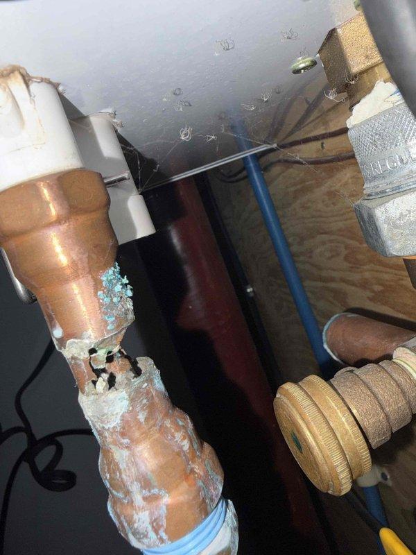 Responded to service call for inoperative floor heating system. Upon inspection, discovered severe frozen condensation and ice buildup on copper supply piping in crawl space, indicating loss of heat circulation to radiant floor heating loops. Frozen conditions on copper lines prevented proper water flow through the system, causing complete heating failure. Inspected pressure relief valve and associated plumbing connections, which showed normal condition with no visible leaks or mechanical defects. System shutdown was determined to be caused by inadequate insulation on supply lines in unconditioned space, allowing pipes to freeze during cold weather conditions. Documented frozen pipe conditions with photographic evidence showing extensive ice formation on copper piping and surrounding components. Advised that pipes will require thawing and proper insulation installation on all exposed copper lines in crawl space to prevent recurrence and restore system operation.