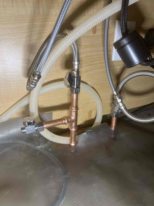 Replaced existing shut-off valves under kitchen sink to accommodate upcoming dishwasher installation. Installed new quarter-turn angle stops with compression fittings on hot and cold water supply lines. Connected braided stainless steel supply lines to existing copper stub-outs. Verified all connections for proper seal and tested system under full pressure with no leaks detected. All valves operate smoothly and are positioned for easy access during future appliance hookup.