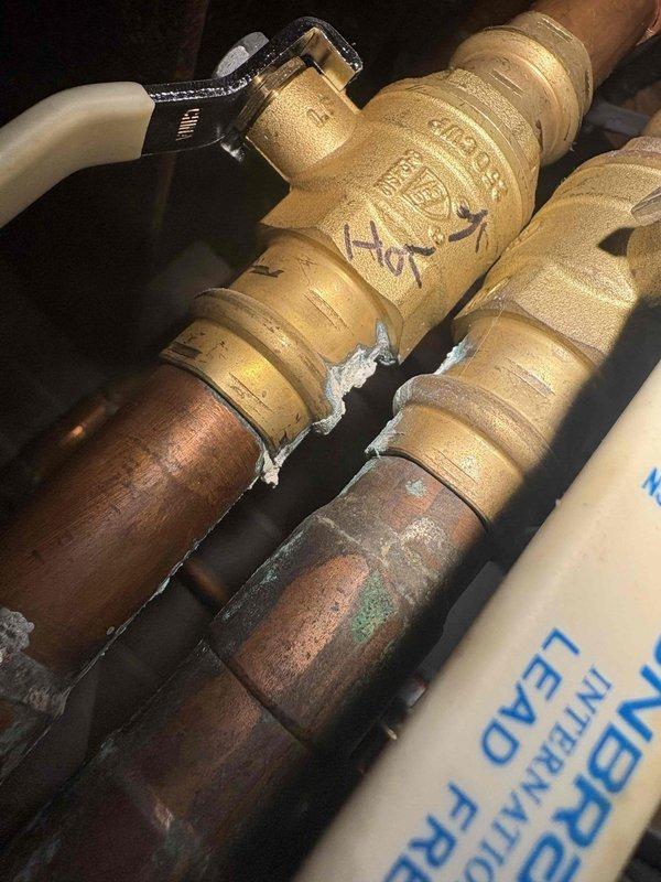 Responded to service call for 50-gallon gas water heater with water accumulation in drain pan. Upon inspection, identified active leak requiring immediate attention. Documented existing plumbing connections including copper supply lines with shutoff valves and confirmed non-power-vented configuration. Advised on emergency shut-off procedures for cold water supply valve and recommended running hot water taps to relieve system pressure if flooding worsens before replacement unit installation.