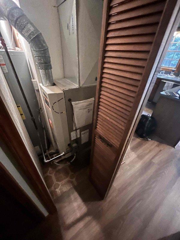 Conducted comprehensive assessment of existing residential HVAC system for equipment replacement estimate. Evaluated current furnace unit located in utility closet, documented equipment configuration including flexible ductwork connections and air handler components. Provided pricing options for complete furnace replacement and added air conditioning system installation to meet customer's request for both heating and cooling upgrade estimates.