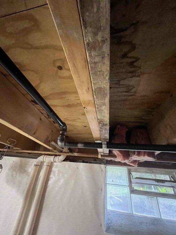 Installed new gas line system with pounds-to-ounce pressure regulator at residential property. Excavation work was coordinated with utility locating services (OUPS ticket #2627101937-000) to safely expose and route the gas supply line to the house. The installation included running black iron pipe through the basement area with proper mounting brackets secured to floor joists, connecting to the pressure regulator system that steps down gas pressure from distribution levels to appliance-safe levels. All work was completed in accordance with local gas code requirements and utility safety protocols.