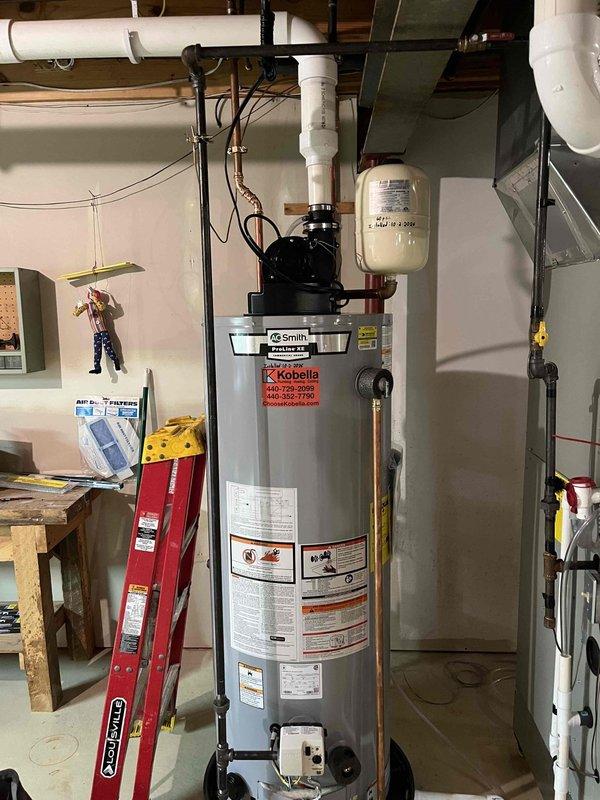 Installed 50-gallon AO Smith power vent water heater in basement utility room. Completed all plumbing connections including copper supply lines and PVC vent piping, installed expansion tank, and verified proper operation of power vent motor assembly.