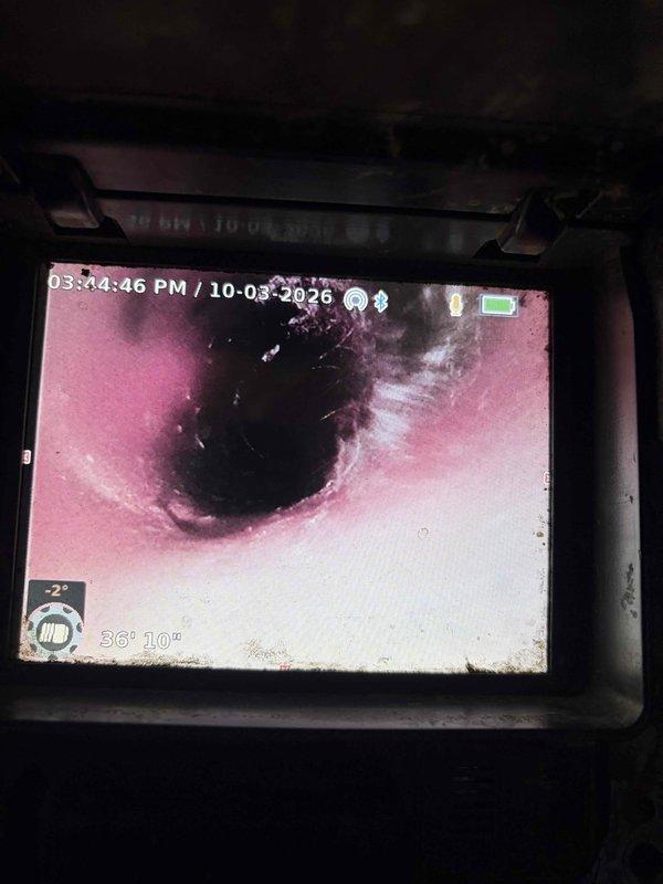 Responded to emergency call for recurring washing machine drain backup. Upon arrival, deployed inspection camera to assess drain line condition and locate obstruction. Camera inspection revealed blockage at approximately 36 feet 10 inches into the drainage system. Utilized professional drain cleaning equipment to clear the obstruction and restore proper drainage flow. Successfully cleared the line and verified proper water flow through the washing machine drain. System tested and confirmed operational upon completion.