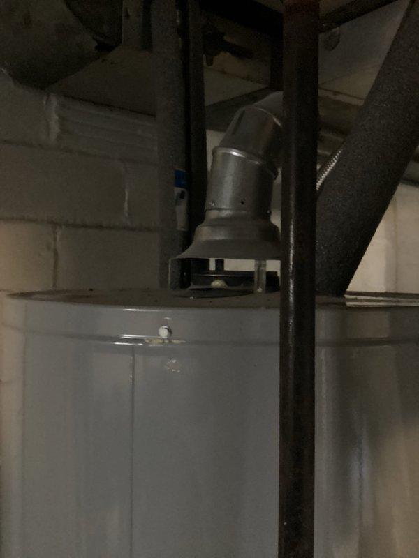 Responded to emergency no-heat call for fourteen-year-old furnace system. Upon arrival, verified thermostat was calling for heat with display showing 68°F inside temperature and 70°F setpoint with "Heat On" status indicated on Honeywell digital thermostat. Inspected furnace installation in basement mechanical room, including venting configuration and overall system condition. Documented equipment setup with water heater proximity and metal flue pipe routing. Performed diagnostic evaluation to identify cause of heating failure and restored heat to residence.