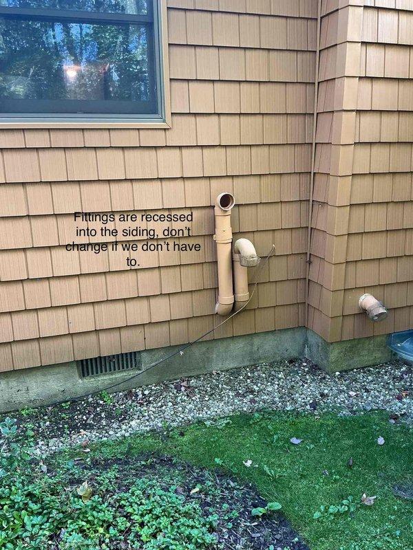 Conducted site assessment of exterior HVAC piping installation on residential property. Documented existing PVC pipe configuration with fittings recessed into wooden shake siding and noted recommendation to preserve current installation to avoid unnecessary modifications. Recorded measurements and created technical sketches for service documentation purposes.