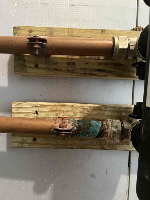 Completed comprehensive maintenance on combi boiler system located in attic space. Performed standard club membership maintenance procedures including system inspection, filter evaluation, and operational checks. Relocated air filtration system as requested, repositioning filters from original location to improve accessibility for future maintenance. Documented existing copper refrigerant line corrosion on lower pipe assembly showing significant verdigris buildup requiring monitoring. Inspected air handler unit, ductwork connections, and evaporator coil assembly—all components found operating within normal parameters. System left in proper working condition with improved filter access for homeowner maintenance.