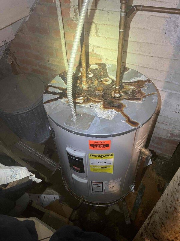 Responded to service call for multiple plumbing issues including unstable toilet fixture, aging water heater system, and malfunctioning shower diverter valve. Inspected toilet installation and found loose floor mounting bolts causing fixture movement. Evaluated water heater condition, noting significant corrosion on top connections and aging infrastructure requiring future replacement consideration. Assessed shower diverter valve malfunction allowing hot water bypass during shower operation. Documented equipment conditions with photographic evidence showing water heater with rust deterioration at pipe connections, corroded support column, and overall mechanical room infrastructure. Provided recommendations for toilet remounting, water heater replacement planning, and shower valve repair to address all identified deficiencies.