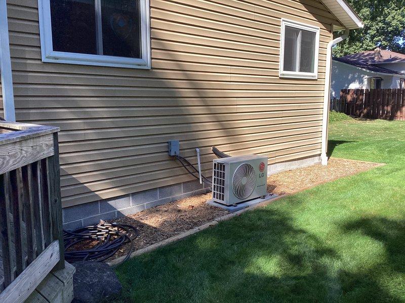 Responded to service call for LG model LS180HEV mini-split wall unit approximately 15 years old experiencing operational failure with indicator lights blinking between heating and cooling modes. Upon arrival, conducted visual inspection of both indoor wall-mounted unit and outdoor condenser unit. Exterior condenser appeared properly installed with refrigerant lines secured along vinyl siding. Assessed system for potential electrical issues, control board malfunction, or mode conflict causing the alternating light pattern and preventing system startup. Documented equipment condition and installation configuration through photographs. Provided customer with estimate for necessary repairs to restore heating and cooling functionality to the mini-split system.