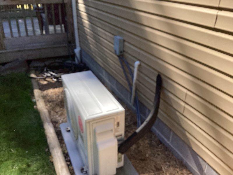 Responded to service call for LG model LS180HEV mini-split wall unit approximately 15 years old experiencing operational failure with indicator lights blinking between heating and cooling modes. Upon arrival, conducted visual inspection of both indoor wall-mounted unit and outdoor condenser unit. Exterior condenser appeared properly installed with refrigerant lines secured along vinyl siding. Assessed system for potential electrical issues, control board malfunction, or mode conflict causing the alternating light pattern and preventing system startup. Documented equipment condition and installation configuration through photographs. Provided customer with estimate for necessary repairs to restore heating and cooling functionality to the mini-split system.