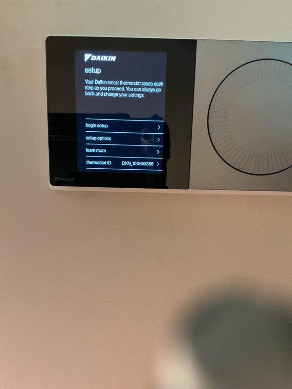 Completed callback for full HVAC system installation. Verified Daikin smart thermostat installation and proper system configuration, confirmed thermostat display showing correct model identification, software version 4.0.07, and WiFi connectivity established for remote operation capability.