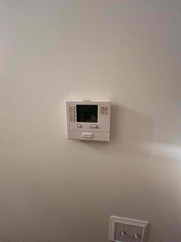 Completed HVAC estimate for replacement of existing Magic Pack heating system. Evaluated current equipment condition, assessed installation location showing exposed framing and ductwork, and reviewed existing thermostat controls to provide comprehensive replacement recommendations for the heating and cooling system.