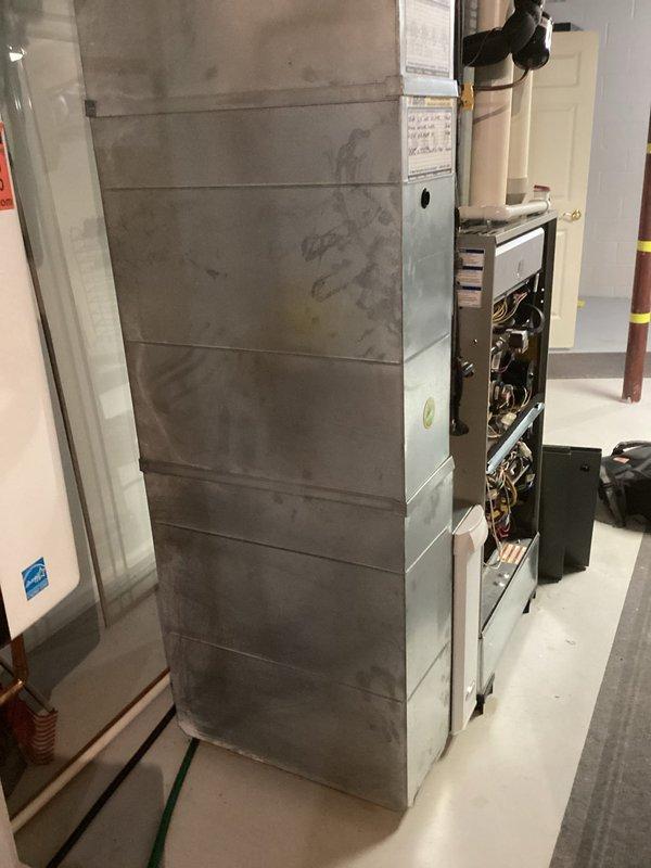 Responded to service call for furnace not heating properly with potential thermostat connectivity issues. Performed diagnostic inspection of residential forced-air heating system, examined internal control components, wiring, and circuit boards with access panel removed. Provided estimate for complete HVAC system replacement including furnace and air conditioning equipment.