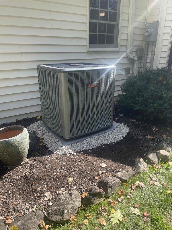 Completed full propane-fired HVAC system installation including new Amana outdoor condensing unit and all associated components. Fabricated custom return air offset and supply plenum in shop using two sheets of metal, then installed gas piping with brass shut-off valves, copper connections, and proper mounting brackets secured to exterior wall. Set condenser unit on white stone pad with proper clearances, completed all refrigerant lines, electrical connections, and system startup procedures to verify proper operation of complete heating and cooling system.