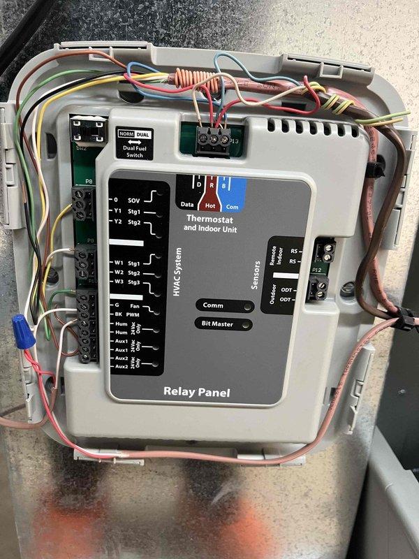 Completed heating maintenance club visit on dual fuel system. Inspected relay panel and thermostat control unit, verifying all terminal connections and dual fuel switch operation with indicator lights functioning properly. Checked air filter condition showing normal dust accumulation and documented system components for member records.