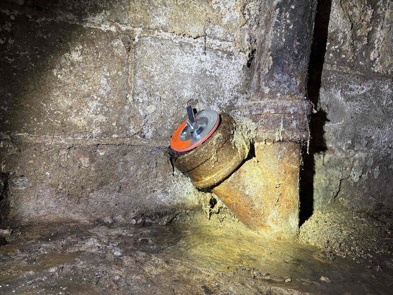 Responded to main line cleanout emergency where the cleanout cap had broken off, causing sewage to spill onto the basement floor. Upon arrival, found the cleanout pipe in the corner junction of the basement with a severely corroded cap that had failed, resulting in active discharge onto the concrete floor. Assessed the damaged cleanout assembly, which exhibited heavy rust and deterioration due to age and moisture exposure. Replaced the broken cleanout cap with a new fitting to restore proper seal and prevent further spillage. Cleaned the affected area where sewage had accumulated on the floor around the pipe base. Verified the new cap was secure and the main line cleanout was properly sealed to prevent future leaks at this access point.