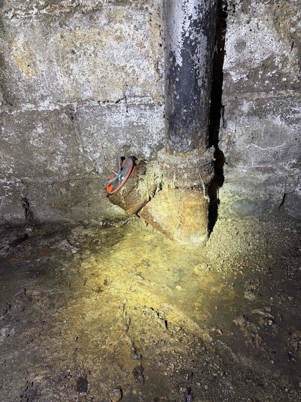Responded to main line cleanout emergency where the cleanout cap had broken off, causing sewage to spill onto the basement floor. Upon arrival, found the cleanout pipe in the corner junction of the basement with a severely corroded cap that had failed, resulting in active discharge onto the concrete floor. Assessed the damaged cleanout assembly, which exhibited heavy rust and deterioration due to age and moisture exposure. Replaced the broken cleanout cap with a new fitting to restore proper seal and prevent further spillage. Cleaned the affected area where sewage had accumulated on the floor around the pipe base. Verified the new cap was secure and the main line cleanout was properly sealed to prevent future leaks at this access point.