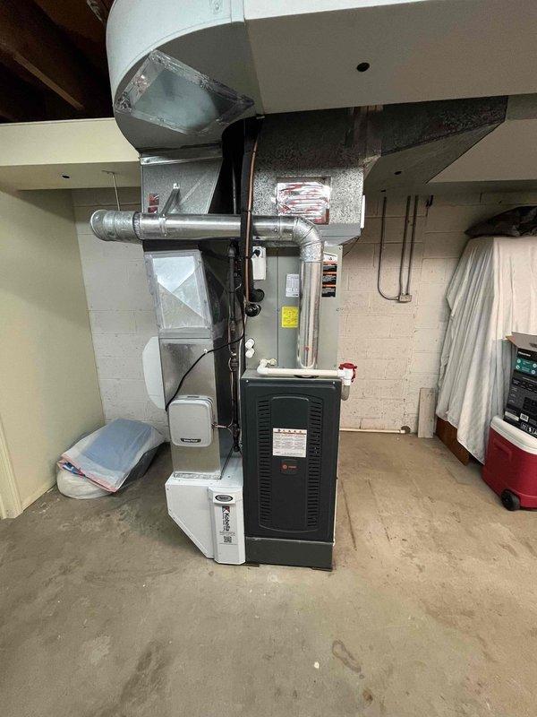 Completed heating maintenance club visit on residential furnace system. Performed comprehensive inspection of gas furnace unit and air handling components located in basement mechanical room. Documented equipment condition through photography, noting evaporator coil with significant dust and debris accumulation requiring attention. Inspected ductwork connections, water heater proximity clearances, and overall system accessibility. Equipment operational at time of service with recommendations provided for filter maintenance and coil cleaning to maintain optimal system efficiency.