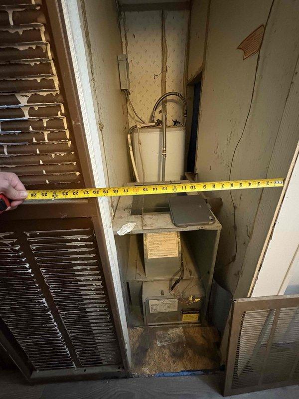 Responded to no-heat call on original 1988 furnace in mobile home with suspected failed blower motor. Upon inspection, confirmed system was approximately 38 years old and had reached end of serviceable life. Assessed installation space constraints by measuring utility closet dimensions to determine replacement equipment options. Provided customer with multiple HVAC system replacement proposals suitable for mobile home application and existing space configuration.