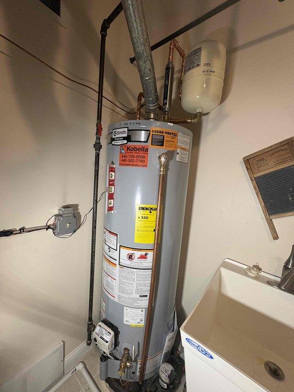Responded to service call for A.O. Smith tanked water heater with pilot light failure that would not remain lit since the weekend. Upon arrival, inspected the unit and its components, including the thermocouple, gas control valve, and pilot assembly. Previous repairs had been completed on this unit in late October. Performed diagnostic testing on the pilot safety system and evaluated the thermocouple probe and gas control valve operation. Discussed repair options versus replacement with tankless water heater system as an alternative solution given the unit's service history and ongoing reliability concerns. Documented current condition of water heater installation, including copper supply lines, expansion tank, venting system, and safety components. Customer is considering conversion to tankless system for improved efficiency and reliability.