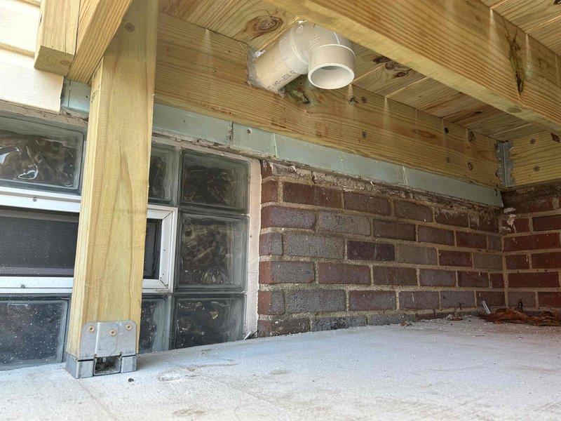 Completed installation of new PVC venting system in basement area, including proper routing through ceiling joists and exterior wall penetration. Modified existing plumbing configuration to accommodate updated drainage requirements, ensuring all connections meet code specifications and proper pitch for drainage flow. Work included coordination with existing glass block windows and foundation elements to maintain structural integrity and weatherproofing at all penetration points.