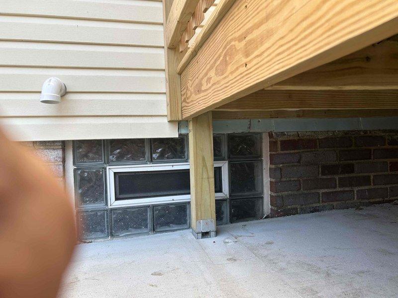 Completed installation of new PVC venting system in basement area, including proper routing through ceiling joists and exterior wall penetration. Modified existing plumbing configuration to accommodate updated drainage requirements, ensuring all connections meet code specifications and proper pitch for drainage flow. Work included coordination with existing glass block windows and foundation elements to maintain structural integrity and weatherproofing at all penetration points.