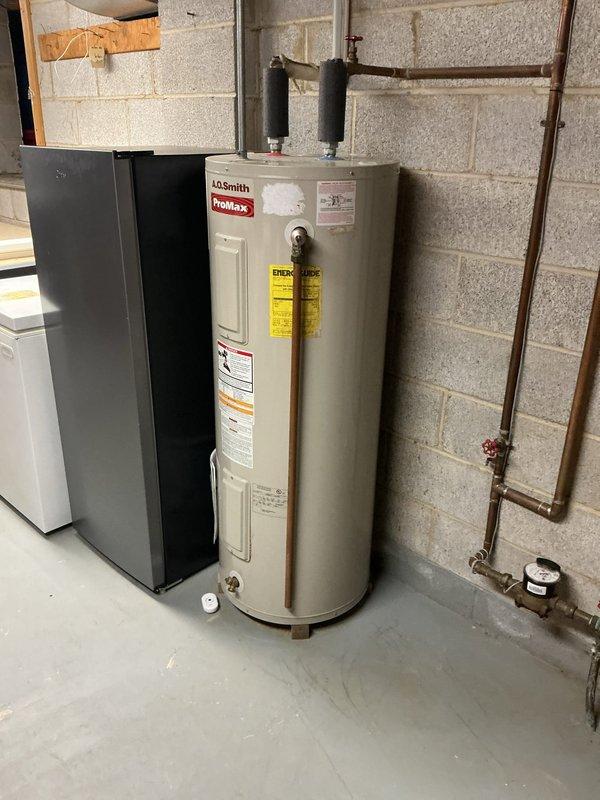 Performed annual heating maintenance on heat pump system installed in 2023, confirming proper operation with no issues identified. Replaced deteriorated copper drain stack with PVC piping to address drainage concerns. Inspected plumbing infrastructure including water meter, main shutoff valve, and water heater connections, noting corrosion on copper piping that was documented for future monitoring.